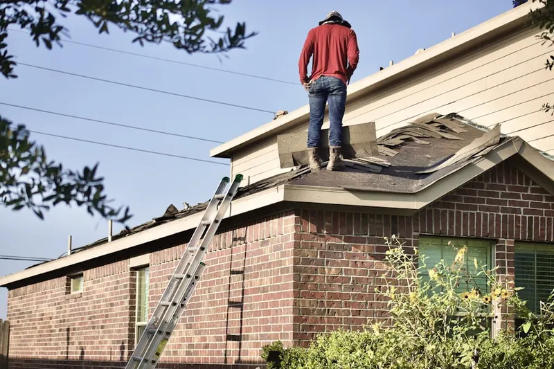 Professional roofer working on a residential roof in North Braintree
